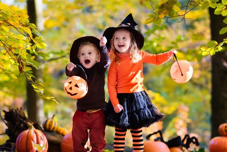 Two children in Halloween costumes in Asbury Woods.